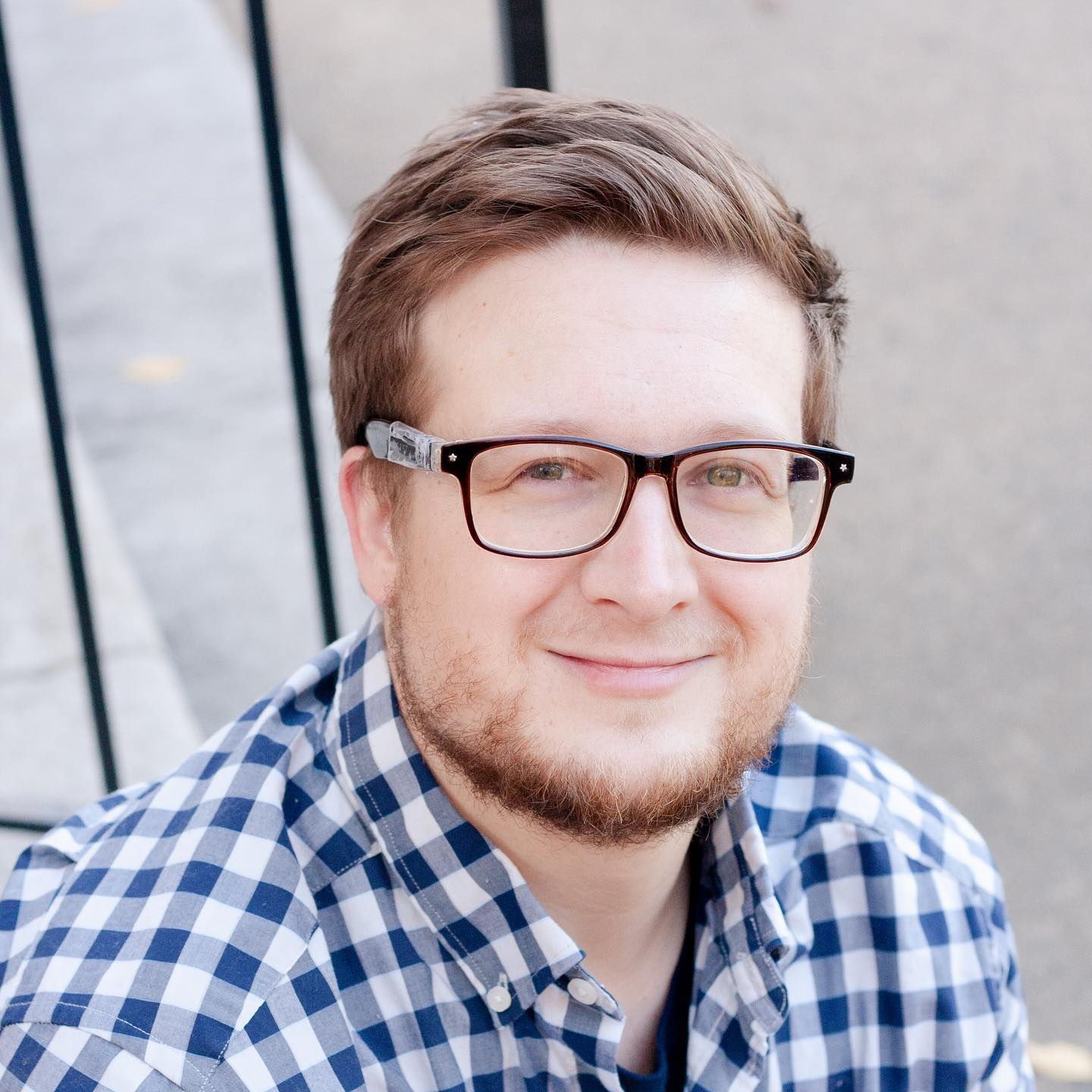 A man with glasses and a plaid shirt.